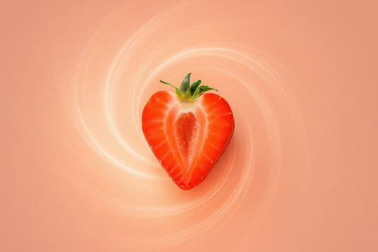 Halved strawberry on soft pink background with swirling light, symbolising clitoral suction and gentle air pulse