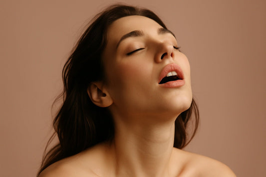 Sensual portrait of a woman with head tilted back and eyes closed, representing orgasmic pleasure — blog featured image for What is an Orgasm by SmootherVibes