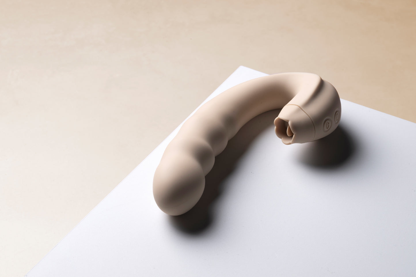 Vanilla clitoral licking vibrator laying on white table surface