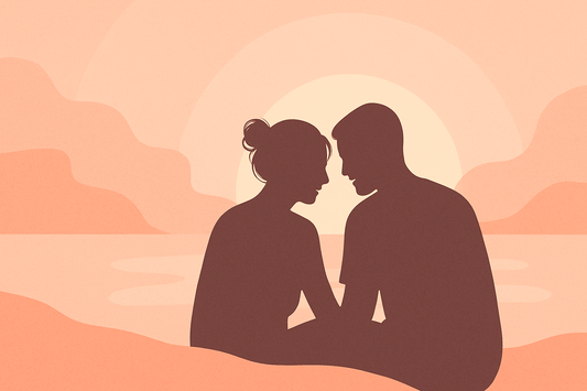 Silhouetted couple sitting close together at sunset, symbolising intimacy, warmth, and emotional connection — used for a blog about sex toys and relationships.