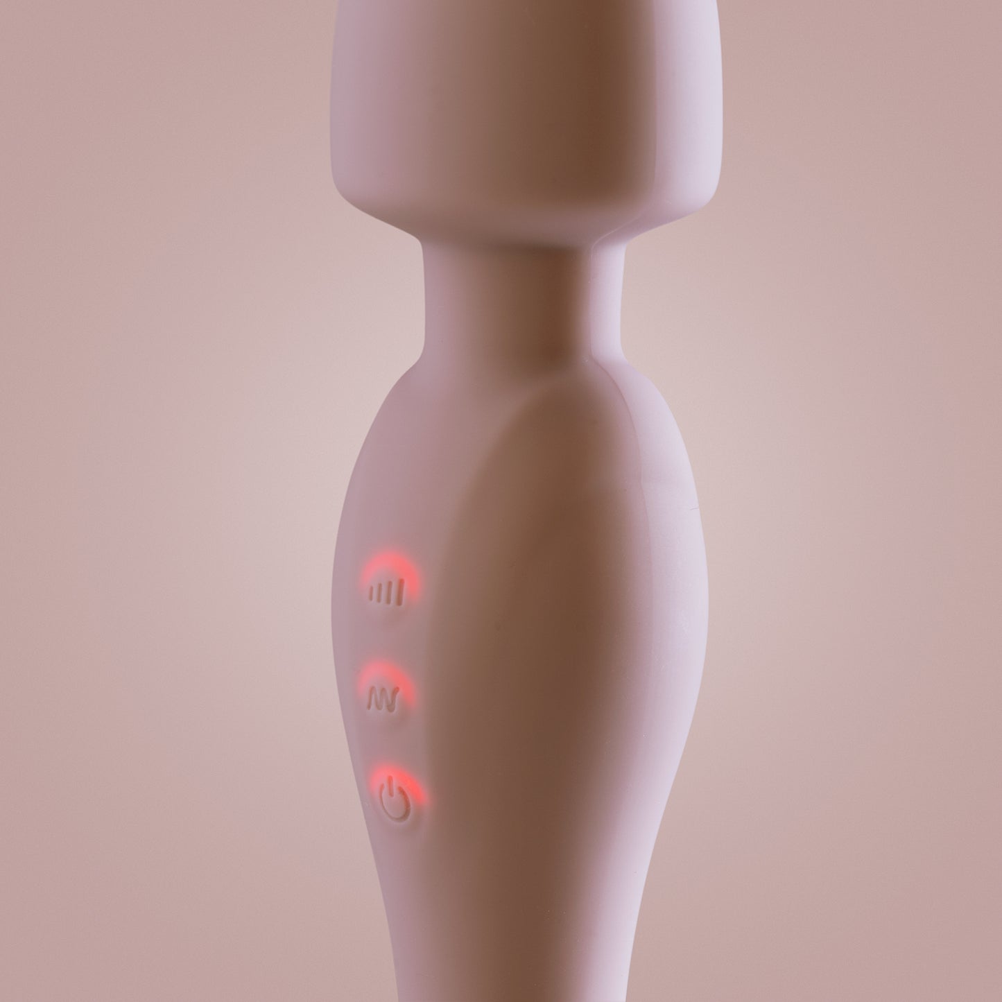 Close-up of pink wand vibrator with power and mode buttons illuminated
